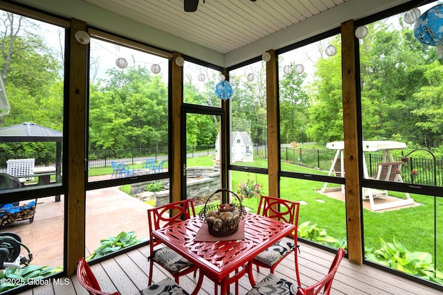 49 N Village Cir, Round Lake, NY 12151 - sunroom / solarium featuring a ceiling fan, outdoor dining space, and view of scattered trees