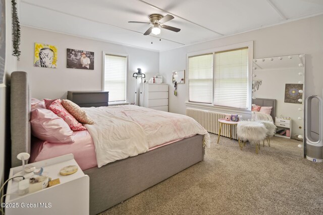 bedroom with radiator, carpet flooring, and a ceiling fan
