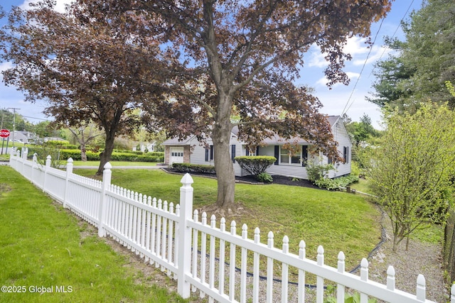 view of property hidden behind natural elements featuring an attached garage