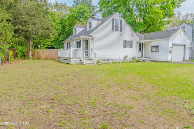 3001 Evelyn Dr, Guilderland, NY 12303 - back of house with an attached garage, a deck, and roof with shingles