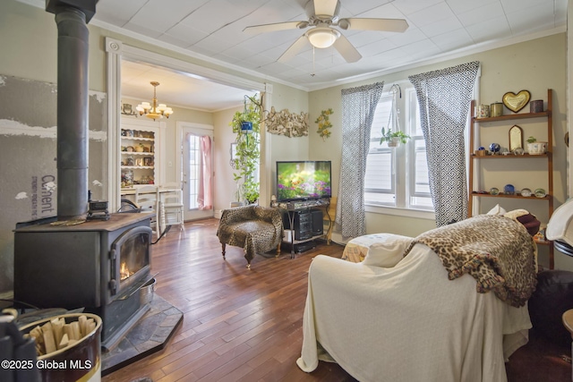 1506 5th Ave, Watervliet, NY 12189 - living room featuring a wood stove, ornamental molding, ceiling fan, plenty of natural light, and hardwood / wood-style flooring