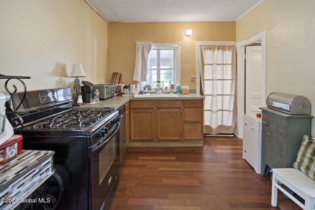 1506 5th Ave, Watervliet, NY 12189 - kitchen featuring gas stove, a sink, dark wood finished floors, light countertops, and brown cabinetry