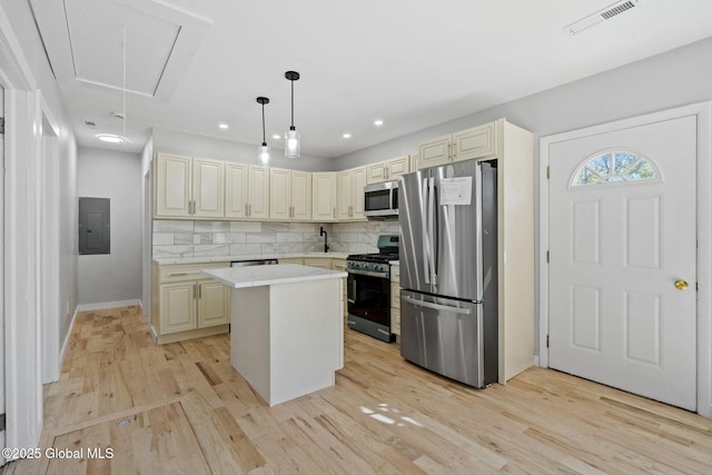 12 Jones Dr, Colonie, NY 12309 - kitchen featuring appliances with stainless steel finishes, cream cabinets, light wood-type flooring, light countertops, and recessed lighting