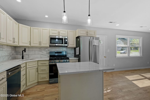 12 Jones Dr, Colonie, NY 12309 - kitchen featuring stainless steel appliances, light wood finished floors, light stone counters, decorative backsplash, and recessed lighting