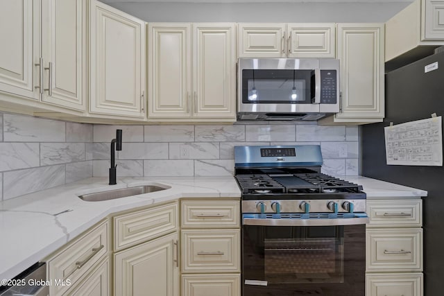 12 Jones Dr, Colonie, NY 12309 - kitchen with stainless steel appliances, cream cabinets, and backsplash