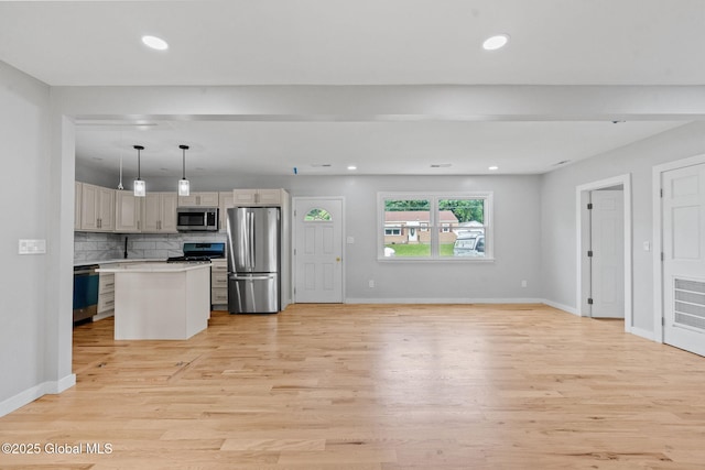 12 Jones Dr, Colonie, NY 12309 - kitchen featuring stainless steel appliances, light wood-style floors, tasteful backsplash, light countertops, and recessed lighting