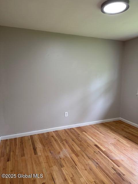 3 Loralee Dr, Colonie Village, NY 12205 - spare room featuring baseboards and light wood-style flooring
