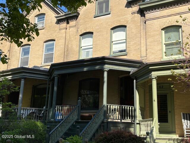 65 S Lake Ave, Albany, NY 12203 - view of front of home with covered porch, brick siding, and stairway