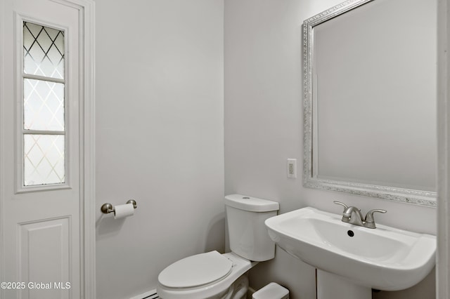 half bathroom with toilet and a sink