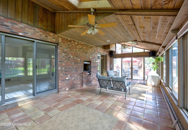 unfurnished sunroom with ceiling fan and a baseboard heating unit