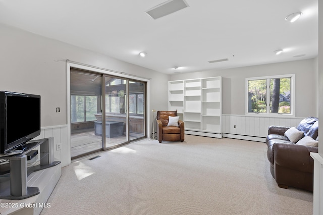 living room with wainscoting, carpet, plenty of natural light, and baseboard heating