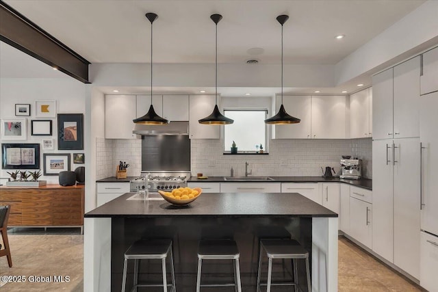 18 Granite St, Saratoga Springs, NY 12866 - kitchen with a sink, dark countertops, backsplash, a kitchen breakfast bar, and white cabinets