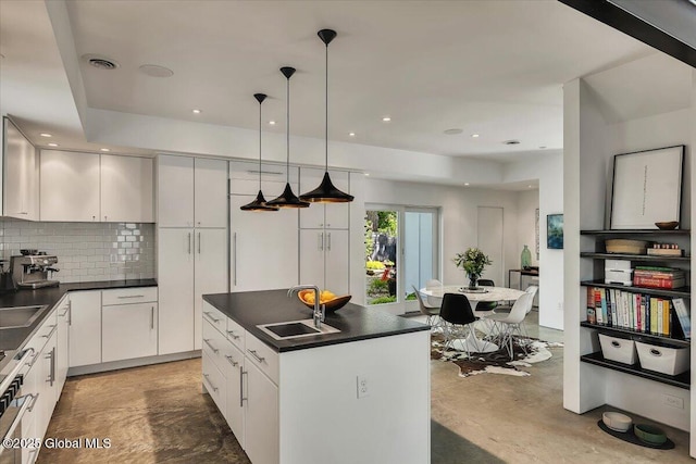 18 Granite St, Saratoga Springs, NY 12866 - kitchen with a sink, dark countertops, backsplash, and pendant lighting
