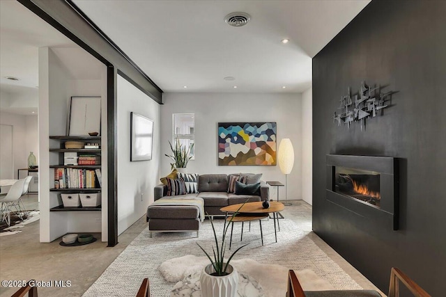 18 Granite St, Saratoga Springs, NY 12866 - living room featuring concrete floors, a warm lit fireplace, and recessed lighting