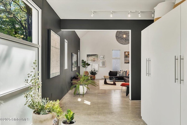 18 Granite St, Saratoga Springs, NY 12866 - corridor featuring vaulted ceiling, concrete floors, and track lighting
