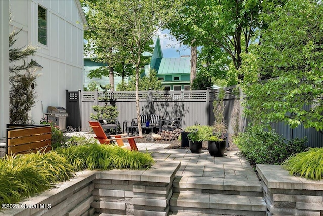 18 Granite St, Saratoga Springs, NY 12866 - fenced backyard with a patio area and grilling area
