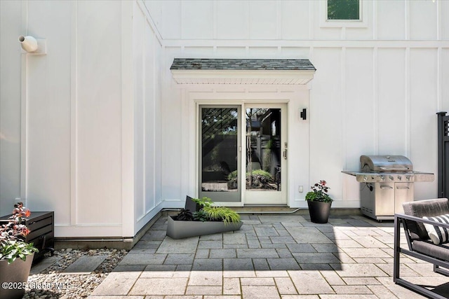 18 Granite St, Saratoga Springs, NY 12866 - property entrance with a patio and board and batten siding