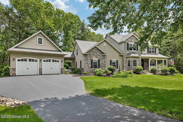 9 Meghan Ct, Wilton, NY 12866 - craftsman-style home with stone siding, a front lawn, and an outbuilding