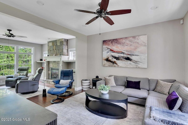 9 Meghan Ct, Wilton, NY 12866 - living area with ceiling fan, wood finished floors, and a fireplace