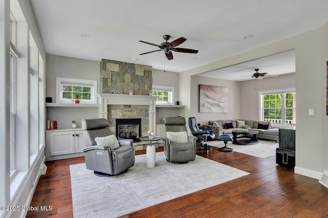 9 Meghan Ct, Wilton, NY 12866 - living room with a ceiling fan, a stone fireplace, dark wood-type flooring, recessed lighting, and baseboards