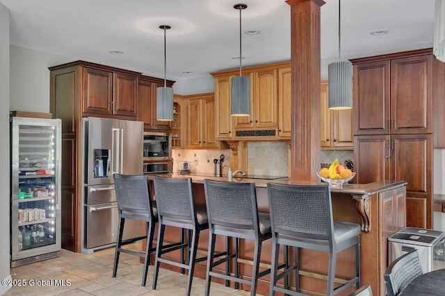 9 Meghan Ct, Wilton, NY 12866 - kitchen with wine cooler, stainless steel fridge with ice dispenser, tasteful backsplash, hanging light fixtures, and recessed lighting