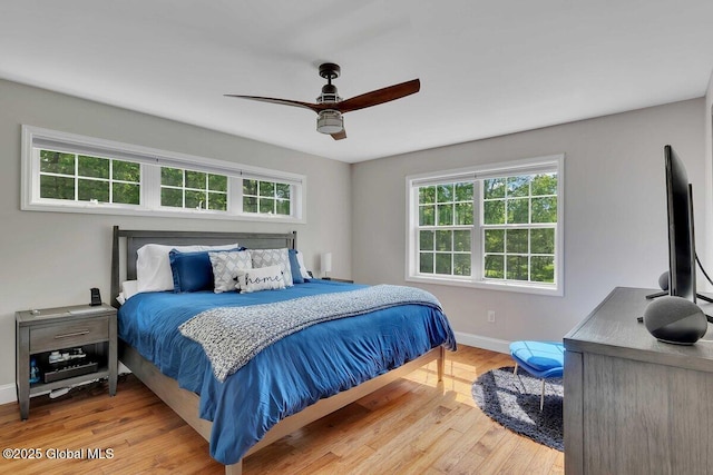 9 Meghan Ct, Wilton, NY 12866 - bedroom featuring multiple windows, baseboards, wood finished floors, and a ceiling fan