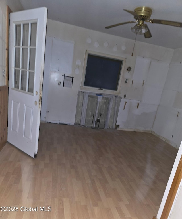unfurnished living room featuring light wood-style flooring and a ceiling fan