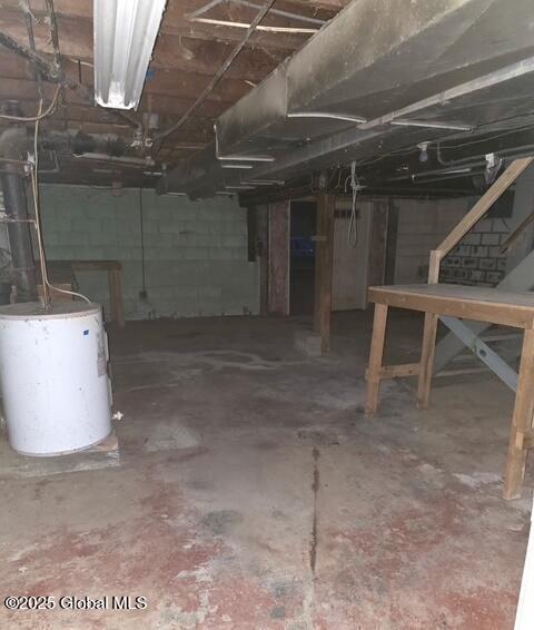 unfinished below grade area featuring water heater