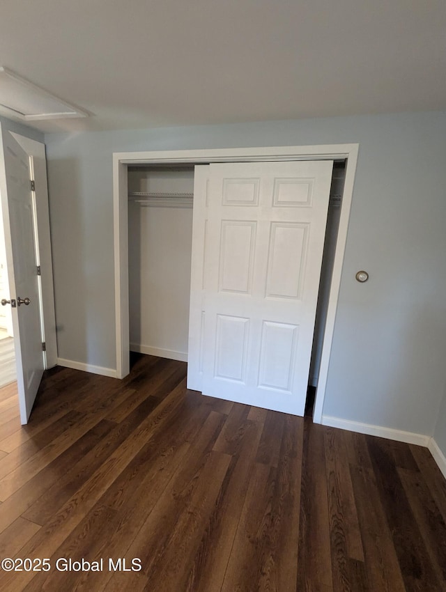 14 W Main St, Fort Plain, NY 13339 - unfurnished bedroom with a closet, dark wood-type flooring, and baseboards