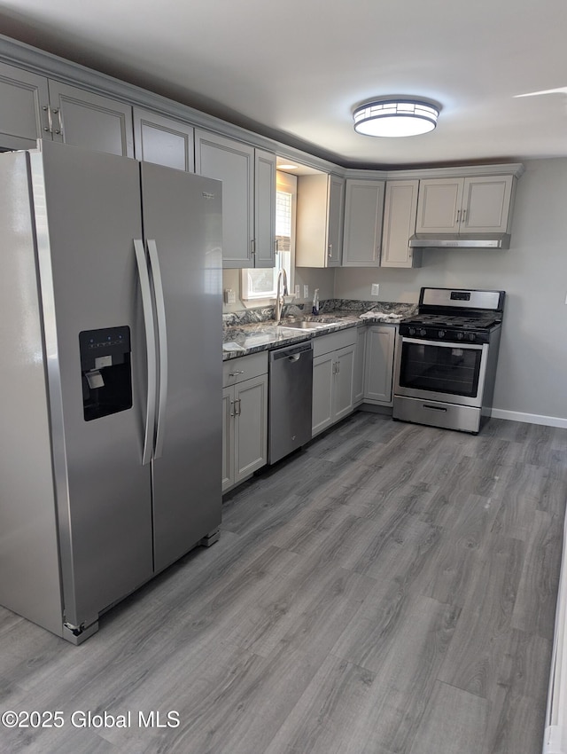 14 W Main St, Fort Plain, NY 13339 - kitchen featuring stainless steel appliances, gray cabinetry, light stone countertops, and light wood-style flooring