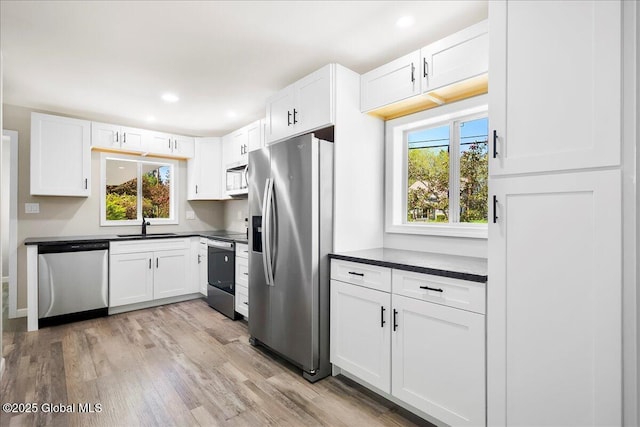 35 Feeder Dam Rd, Moreau, NY 12803 - kitchen with stainless steel appliances, a sink, dark countertops, healthy amount of natural light, and recessed lighting