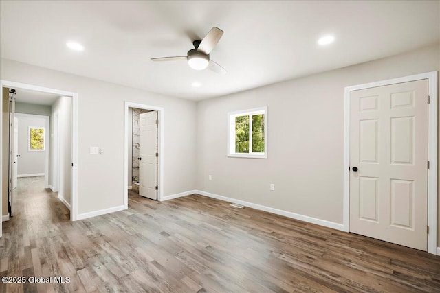 35 Feeder Dam Rd, Moreau, NY 12803 - unfurnished bedroom with multiple windows, wood finished floors, baseboards, and recessed lighting