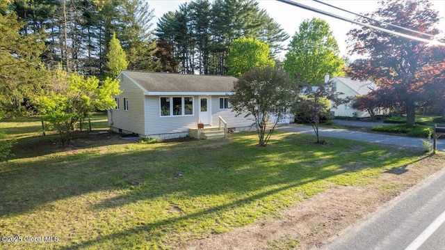 35 Feeder Dam Rd, Moreau, NY 12803 - view of front of home with concrete driveway, a front yard, entry steps, and roof with shingles