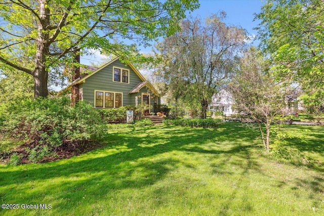 back of property featuring a yard