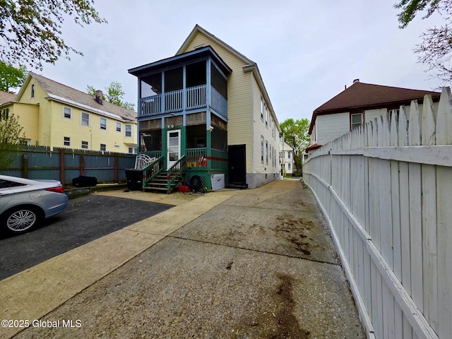 exterior space with a balcony and fence