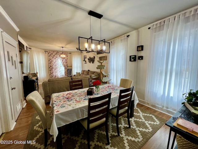 dining room with a chandelier and wood finished floors