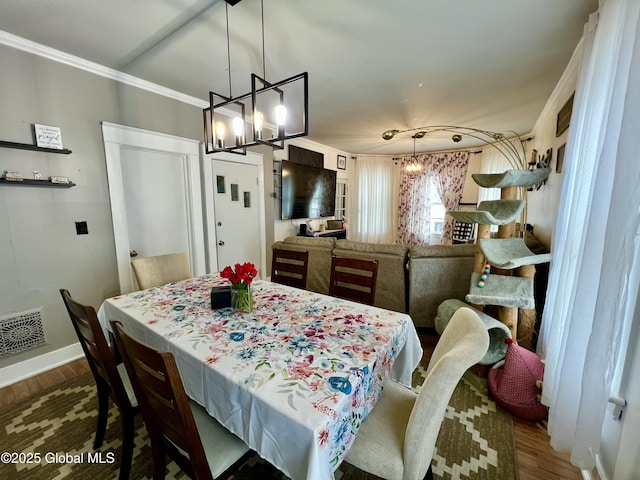 dining space with a chandelier, dark wood-style floors, crown molding, and baseboards