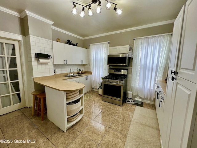 kitchen with appliances with stainless steel finishes, open shelves, white cabinetry, a sink, and crown molding