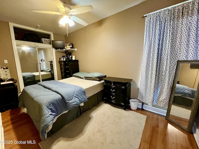 bedroom with wood finished floors, a closet, and ceiling fan