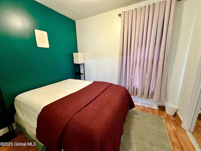 bedroom with wood finished floors