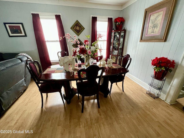 dining space with wood finished floors and baseboards