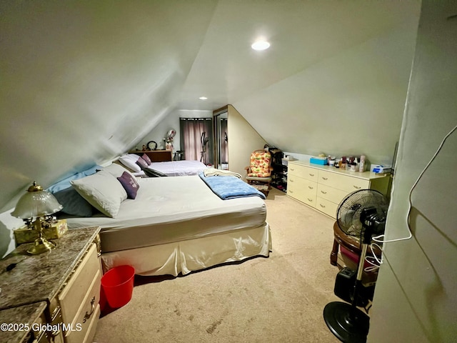 bedroom with carpet floors and vaulted ceiling