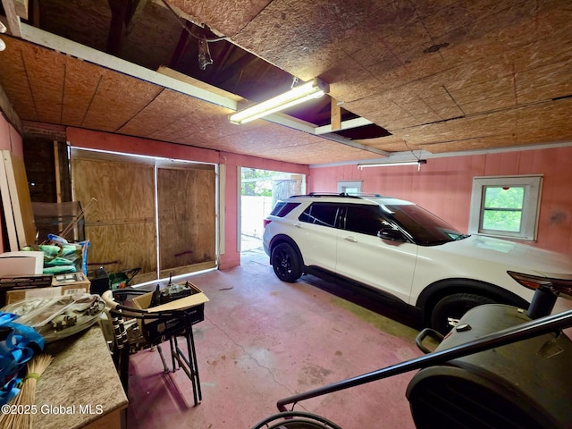 garage featuring wood walls