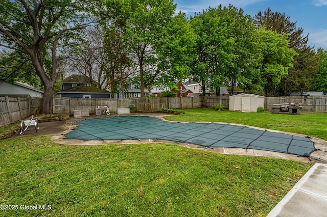 view of pool with a shed, an outbuilding, and a patio