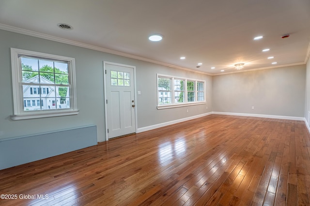 foyer entrance featuring crown molding, hardwood / wood-style flooring, baseboards, and recessed lighting
