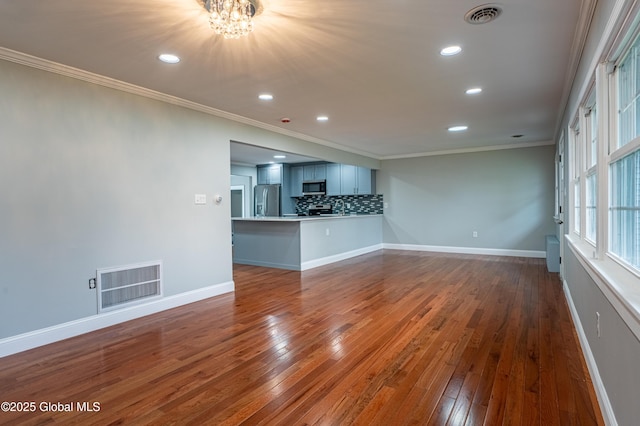 unfurnished living room featuring ornamental molding, a chandelier, dark wood-style floors, recessed lighting, and baseboards