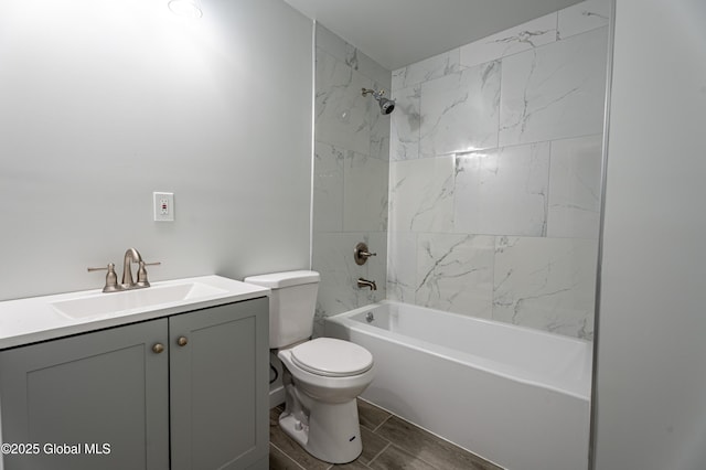 bathroom featuring toilet, vanity, bathtub / shower combination, and wood finish floors