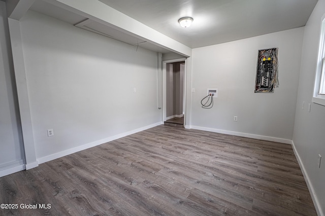 finished basement featuring dark wood finished floors and baseboards