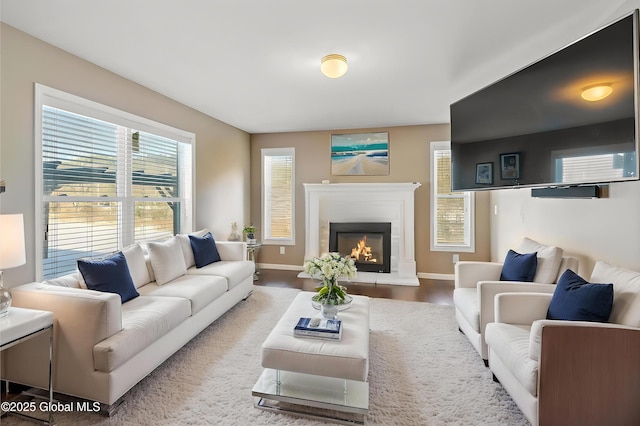 23 Line Dr, Brunswick, NY 12180 - living area featuring a lit fireplace, baseboards, and wood finished floors