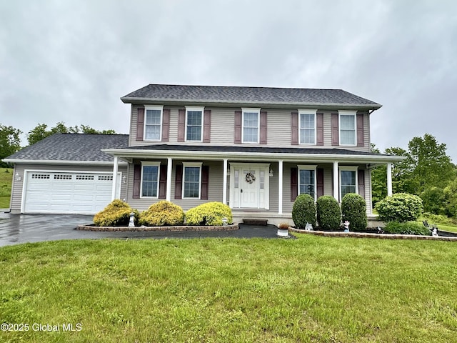 23 Line Dr, Brunswick, NY 12180 - colonial-style house with asphalt driveway, a porch, a garage, and a front yard
